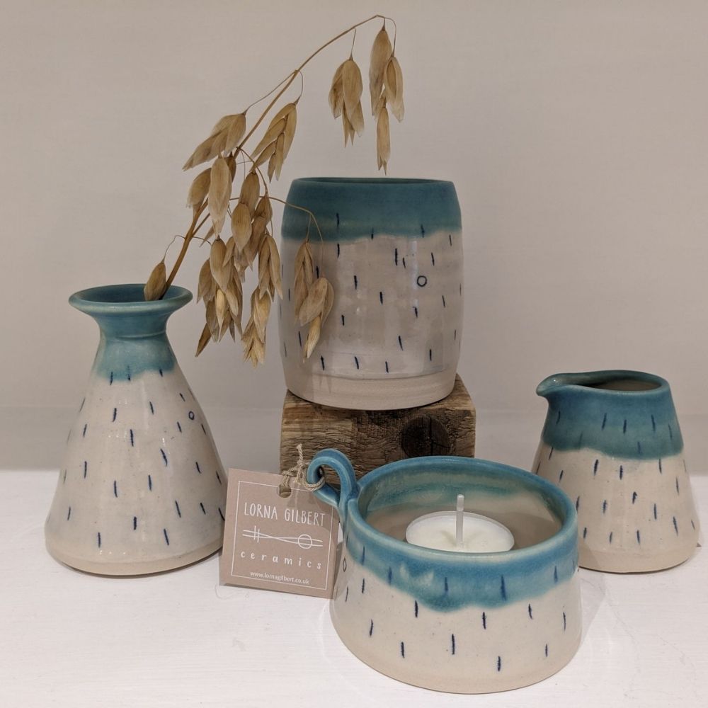 Handmade ceramic vases, jug and candle holder with teal glaze, cream bodies and fine blue dash detailing.