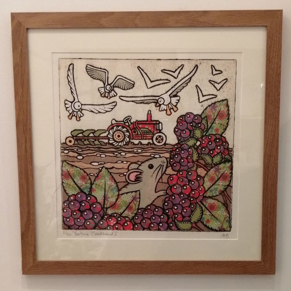 Framed countryside artwork featuring a small mouse among blackberries, with birds flying above a red tractor in the background.