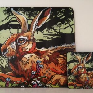 Matching placemat and coaster featuring a colourful illustrated hare resting among flowers and woodland foliage.