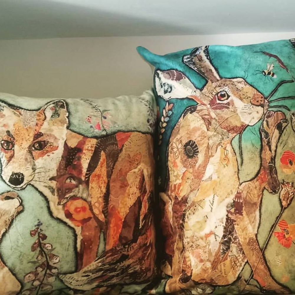 Decorative cushions featuring colourful woodland animal illustrations of a fox and hare.